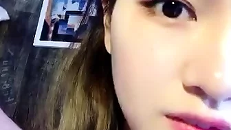 Asian teen sucking a cock in a close up video