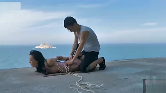 Chinese girl public bondage seaside